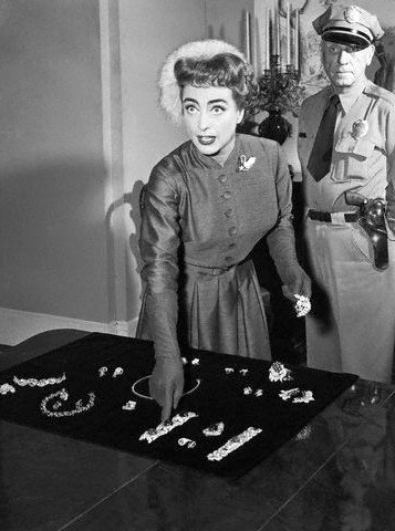 May 2, 1955. Showing off jewels worn in 'Queen Bee.'