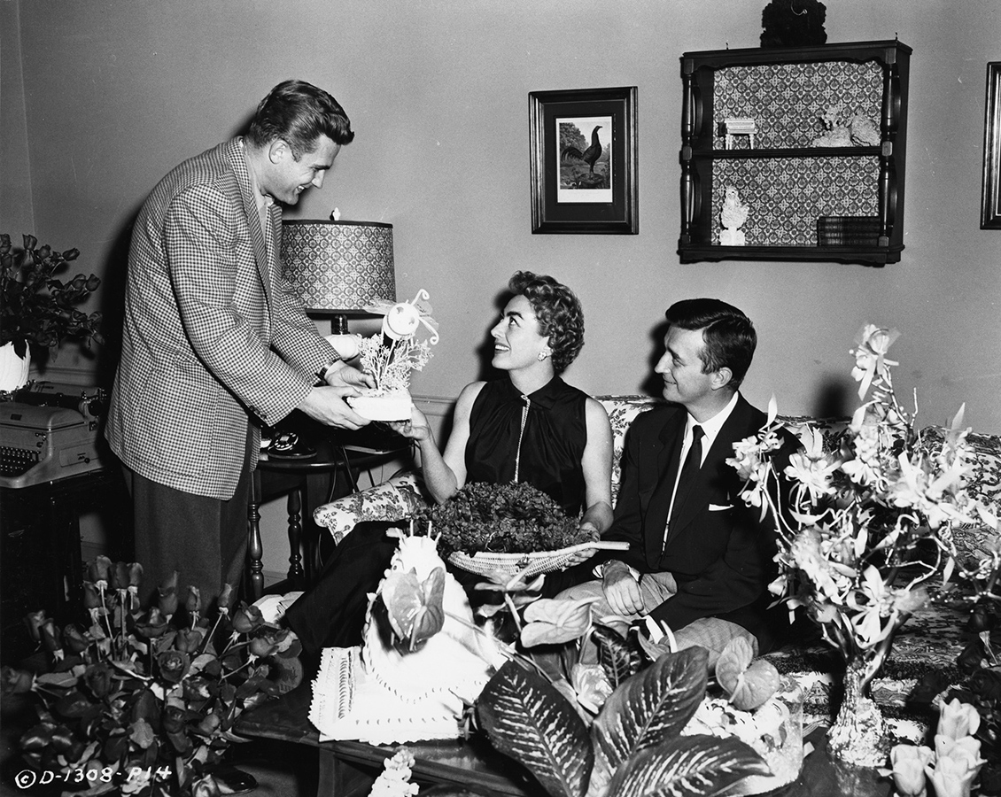 1955. On the set of 'Queen Bee' with co-star Bill Leslie, left, and director MacDougall.