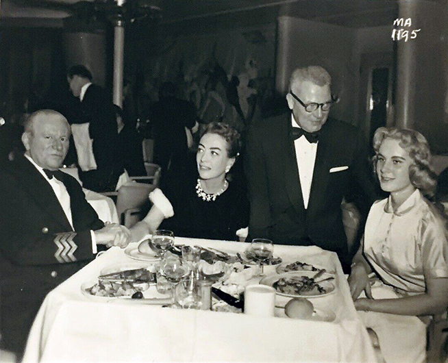 1955. Aboard the 'Queen Mary' with captain, Al Steele, and Christina.