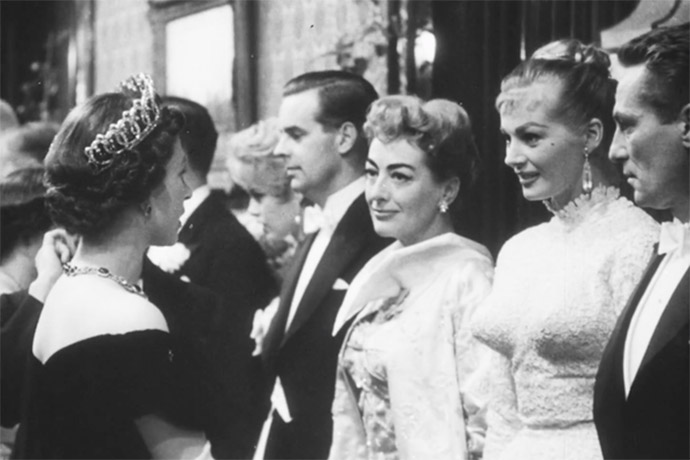 October 29, 1956. Being presented to the Queen at the Empire Theatre. With Anita Ekberg and Peter Finch.