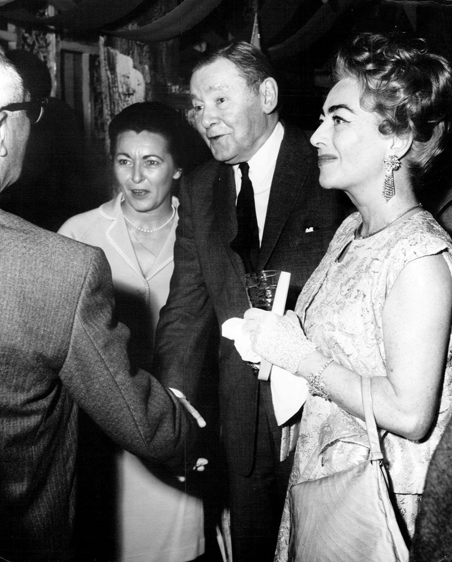1962. At a Hollywood party in her honor, with Mr. and Mrs. Herbert Marshall.