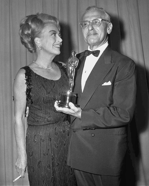 At the 4/15/65 Oscars with Best Director George Cukor. (Thanks to Bryan Johnson.)