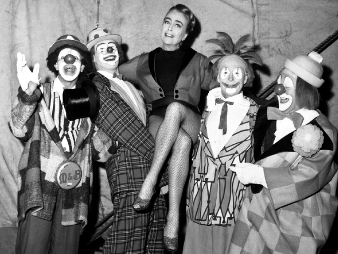 On the set of 'Berserk' with clowns from the Billy Smart Circus.