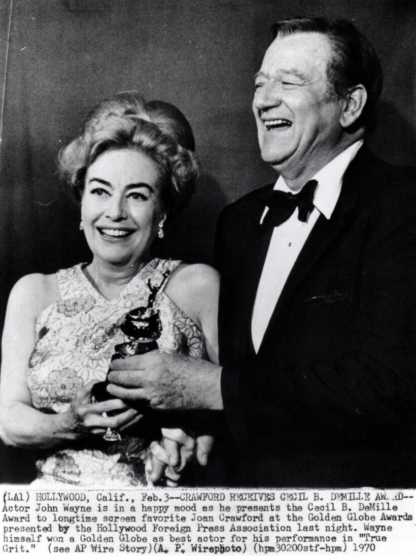 Joan receives the Cecil B. DeMille Award at the 1970 Golden Globes. With John Wayne.