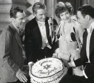 Director Jack Conway, left, celebrates Joan's birthday on the set of 1929's 'Our Modern Maidens' with Doug Fairbanks Jr and Rod LaRocque (right).