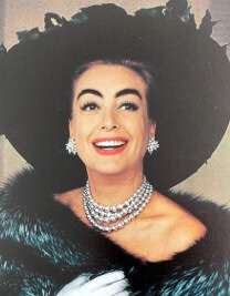 1960, wearing Haskell-designed necklace.