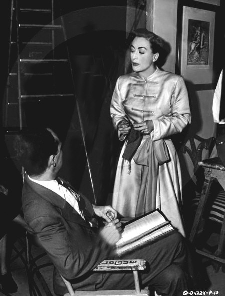 1950. On the set of 'Harriet Craig' with director Vince Sherman.