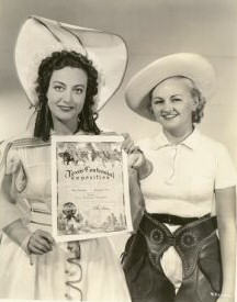 1936. On the set of 'Hussy' with a Texas Rangerette.