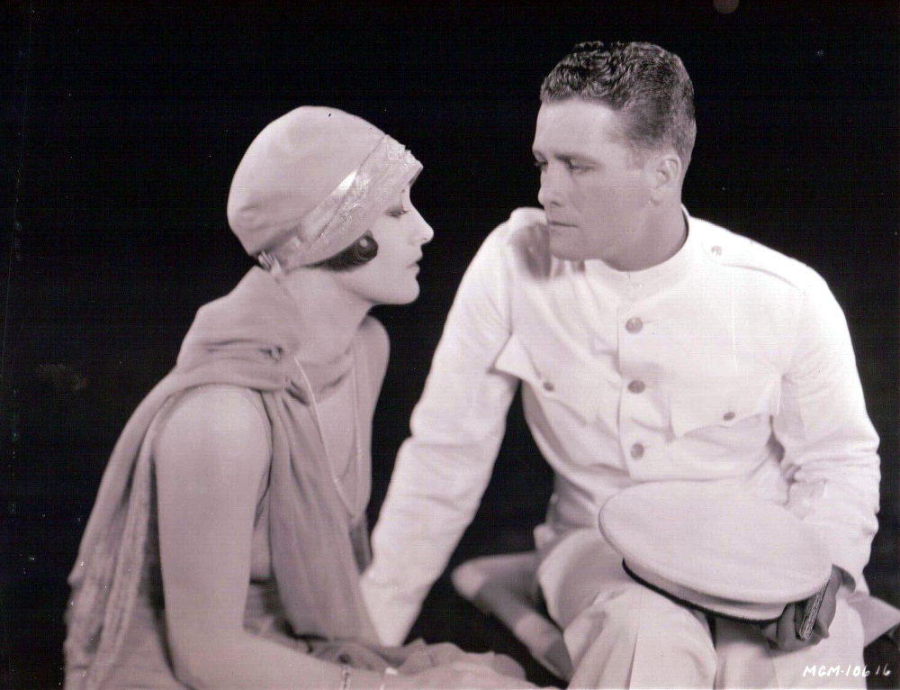 1928. Joan Crawford with West Point cadet.