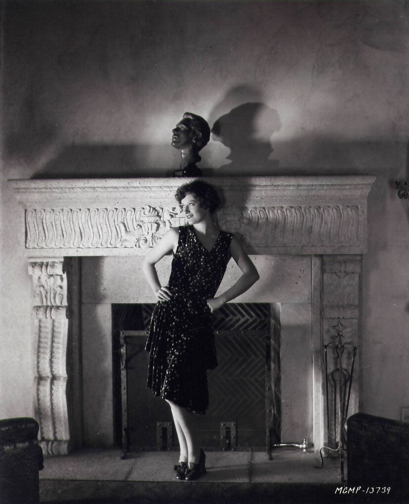 1929 publicity at home in front of husband Doug's bust. Shot by Ruth Harriet Louise.