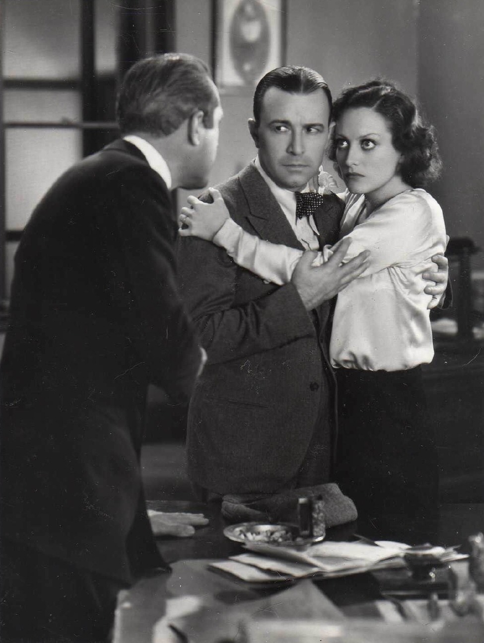 1930. 'Paid' film still with Robert Armstrong.