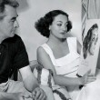 1936. With artist James Montgomery Flagg and his portrait of her. Shot by Bud Graybill.