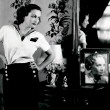 1931. Shot in Joan's dressing room by Hurrell. With Dietrich picture.