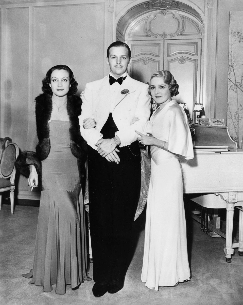 1932. At Pickfair with husband Doug Fairbanks, Jr., and Mary Pickford.