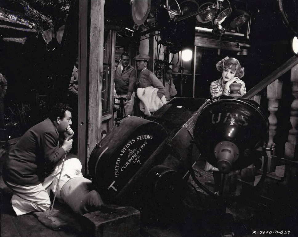 1932. On the set of 'Rain' with director Lewis Milestone.