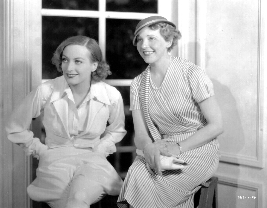 1934. On the set of 'Chained' with Austrian actress Mady Christians.