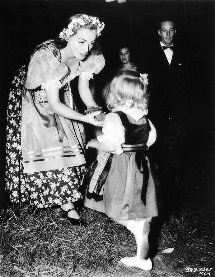 1937. On the set of 'The Bride Wore Red' with niece Joanie LeSueur.