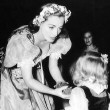 1937. On the set of 'The Bride Wore Red' with niece Joanie LeSueur.