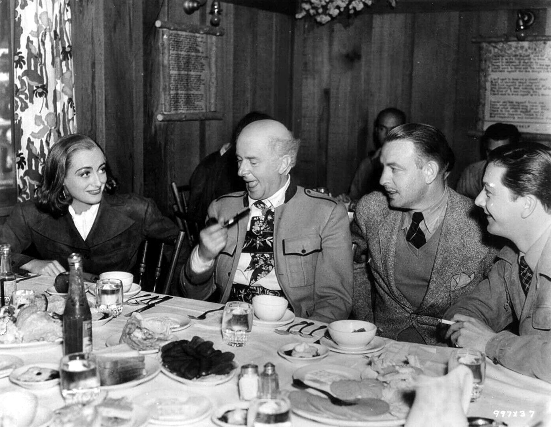 1937. On the set of 'The Bride Wore Red' with Reginald Owen (next to Joan) and Robert Young (right).