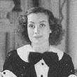 1936. Joan at home, with dress by Hattie Carnegie.