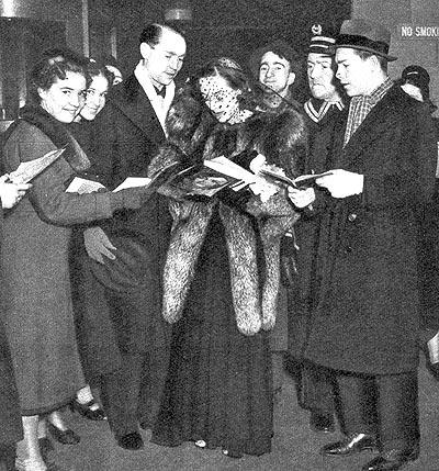 Feb. 1938, with Franchot Tone and fans in NYC.