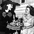 1938. Joan visits Shirley Temple on the set of 'Little Miss Broadway.'