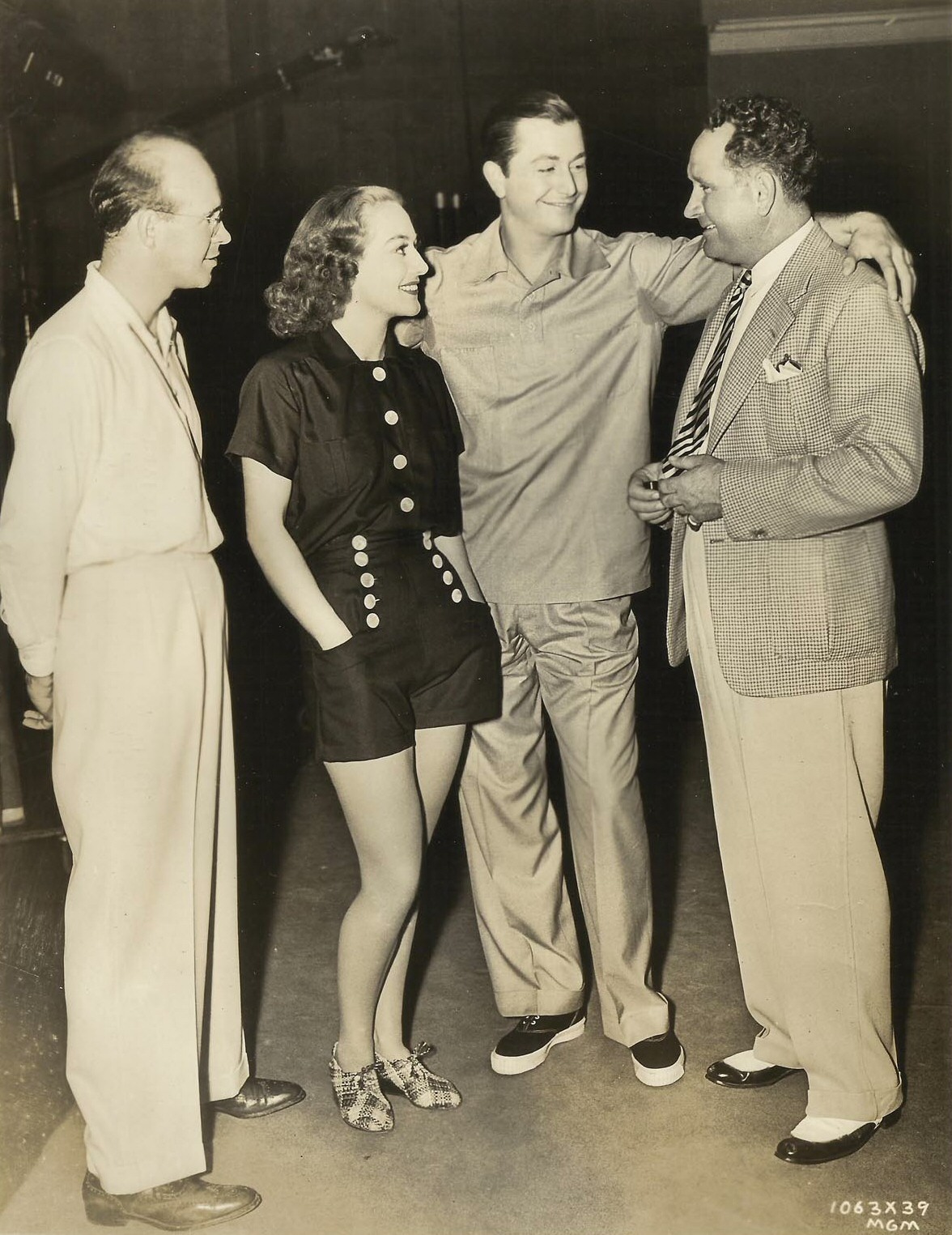 1938. On the set of 'The Shining Hour.' With cameraman George Folsey, Robert Young, and director Frank Borzage.