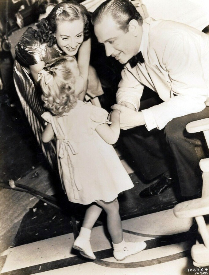 1938. With Melvyn Douglas and niece Joanie on the set of 'The Shining Hour.'