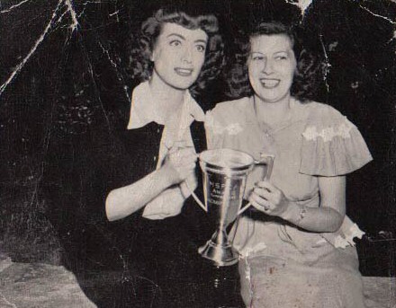 June 1946. On the set of 'Possessed' with fan club president Edith Clemens.