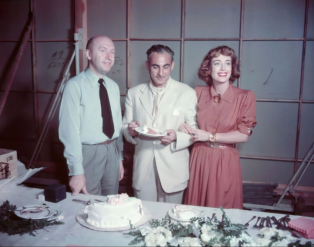 1947. On the set of 'Daisy Kenyon,' with director Preminger, left.