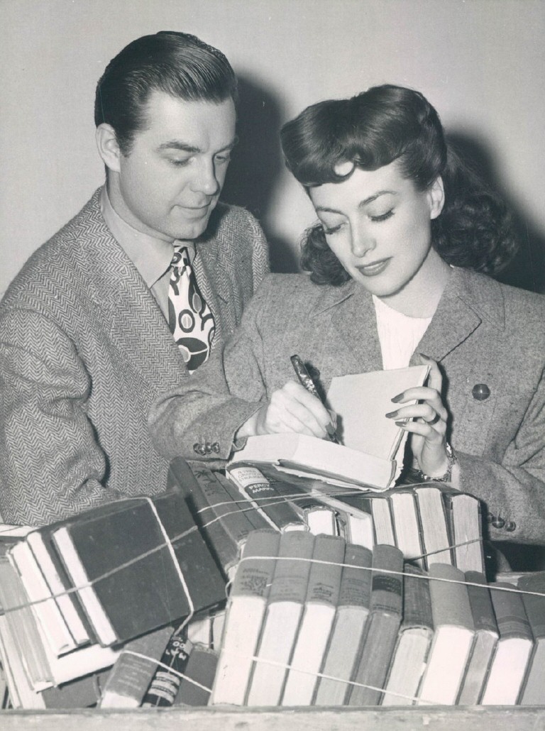 1943 at an MGM book drive, with husband Phillip Terry.