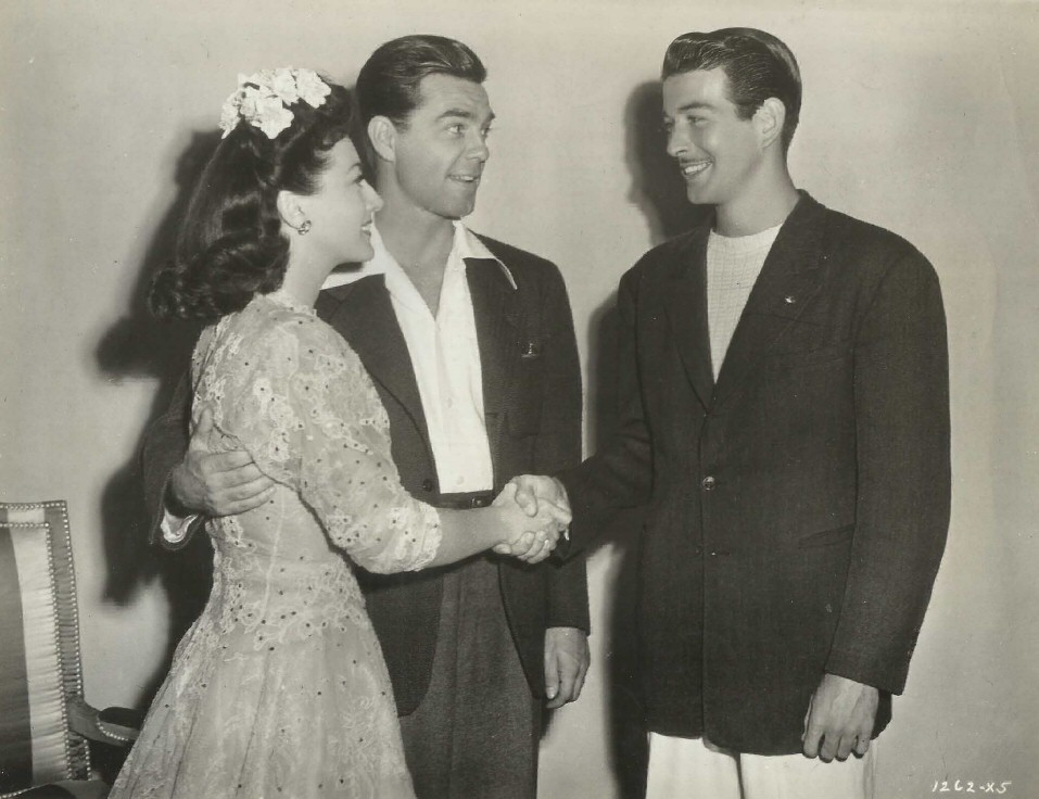 1942. On the set of 'Reunion in France' with husband Phil Terry and actor Bert Hicks.