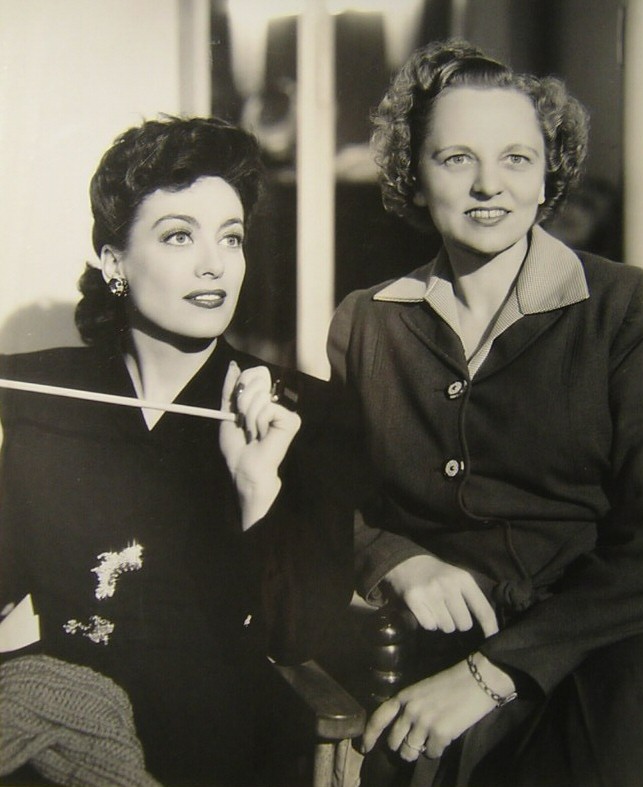 1942. On the set of 'They All Kissed the Bride' with secretary Almeda Dewey.