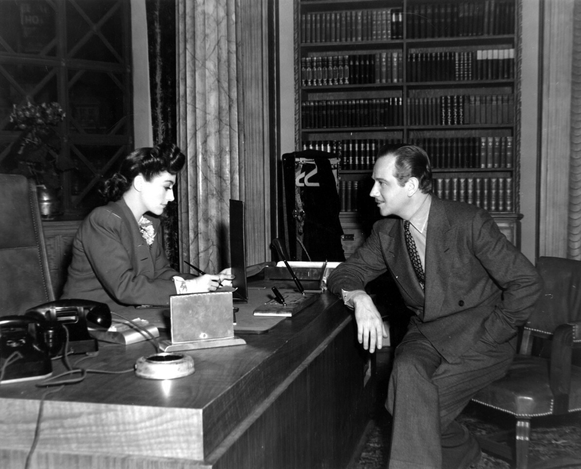 1942. On the set of 'They All Kissed the Bride' with Melvyn Douglas.