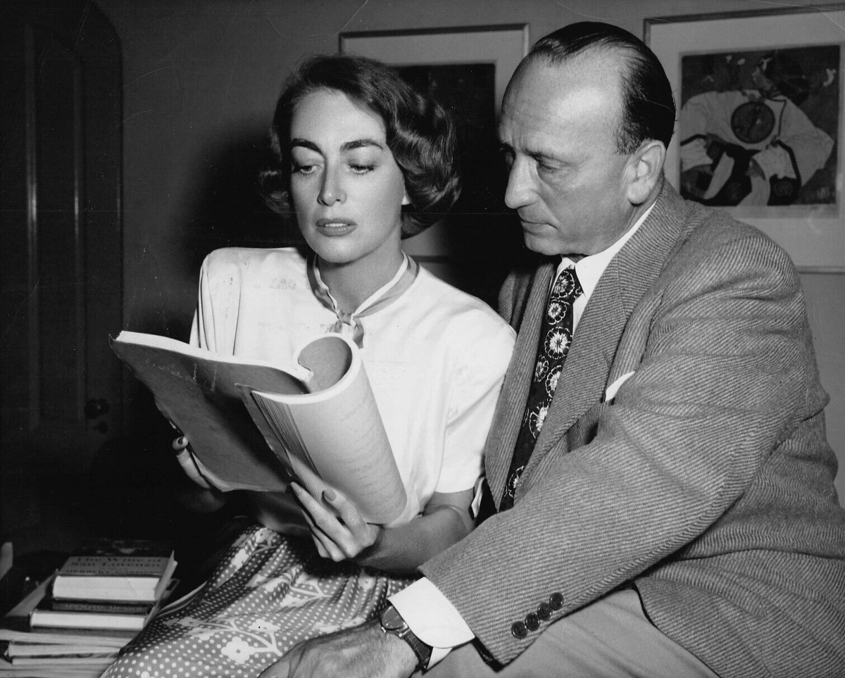 1949. On the set of 'Flamingo Road' with director Mike Curtiz.