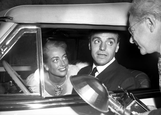 1948 at Ciro's with lawyer Greg Bautzer. In the Cadillac that Joan had given him.