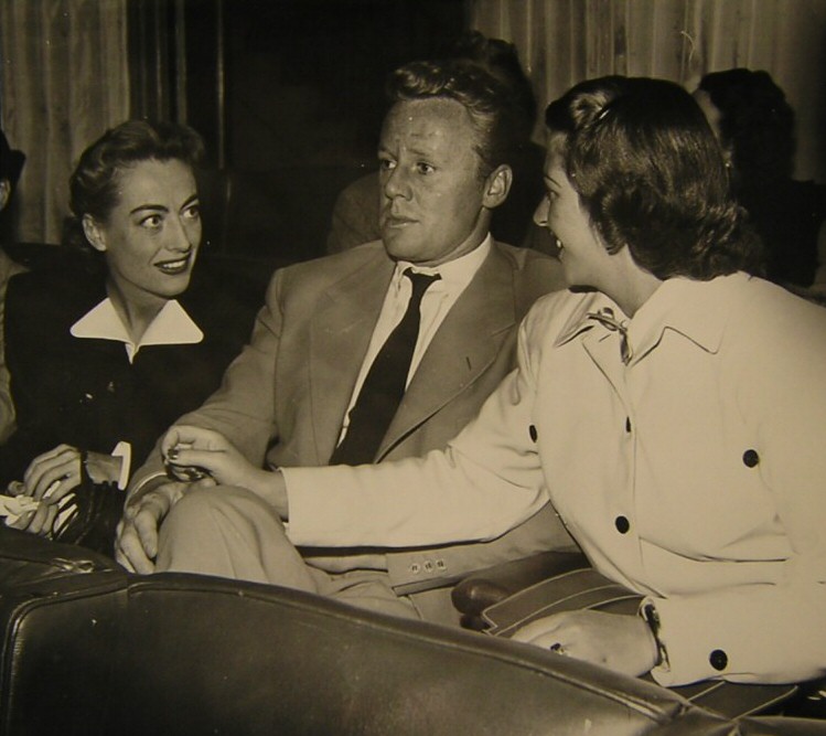 1947. At a press preview for 'Possessed,' with Van and Evie Johnson.