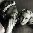 1953. Making up in blackface with Christina looking on. Shot by Sanford Roth.