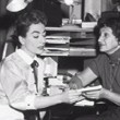 1955. On the set of 'Female on the Beach' with secretaries.