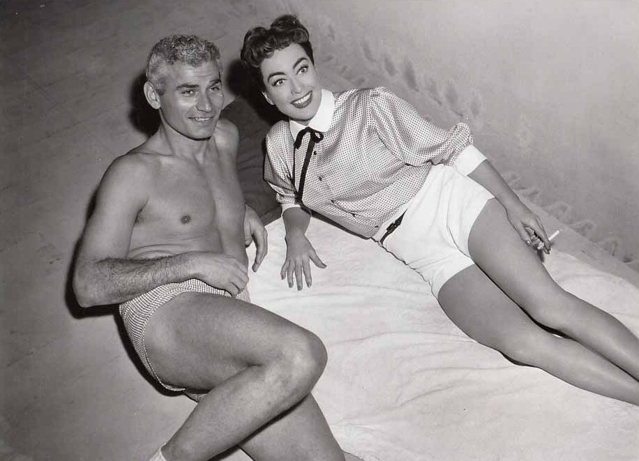 1955. On the set of 'Female on the Beach' with Jeff Chandler.