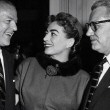 May 1955 at a Columbia party honoring Joan. With exec, left, and husband Al Steele. (Includes press caption.)