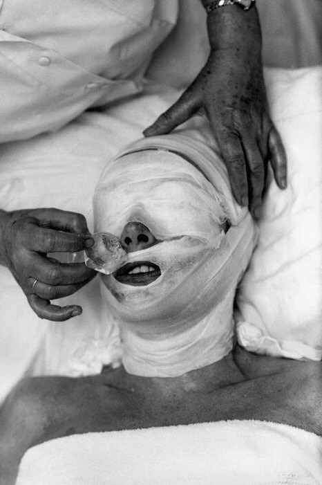 Life magazine, 10/05/59. Original caption: 'At the end of her twice-weekly facial, Joan Crawford's head is wrapped in gauze to prevent burns from ice that is applied to tighten her skin and close her pores. This treatment leaves her relaxed, refreshed and ready for more work.'  By Eve Arnold.