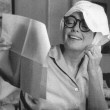 Life magazine, 10/05/59. Original caption: 'A towel wrapped around her freshly washed hair, Joan reads her fan mail. She estimates that between her Pepsi-Cola and fan mail, now increasing as a result of the release of her old films on TV, she gets about 10,000 letters a month.' By Eve Arnold.