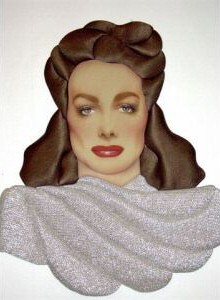 By Dale. Mixed media (satin hair, silver lame dress material). 21 x 17 inches. Year unknown.