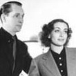 1936. Joan at home with husband Franchot Tone.